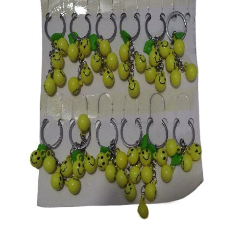 Bright Yellow Smiley Face Ball Keychain with Green Leaf Accent - Durable Plastic Design. - Abid Cart